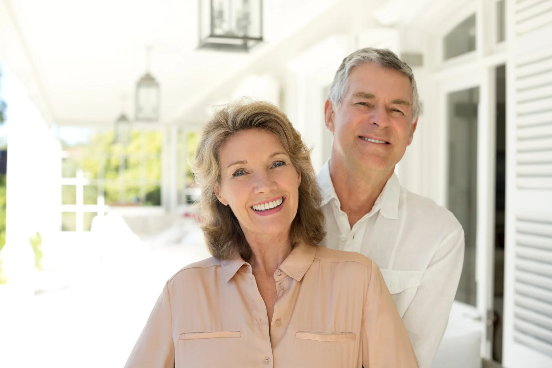 Portrait of senior couple smiling on porch