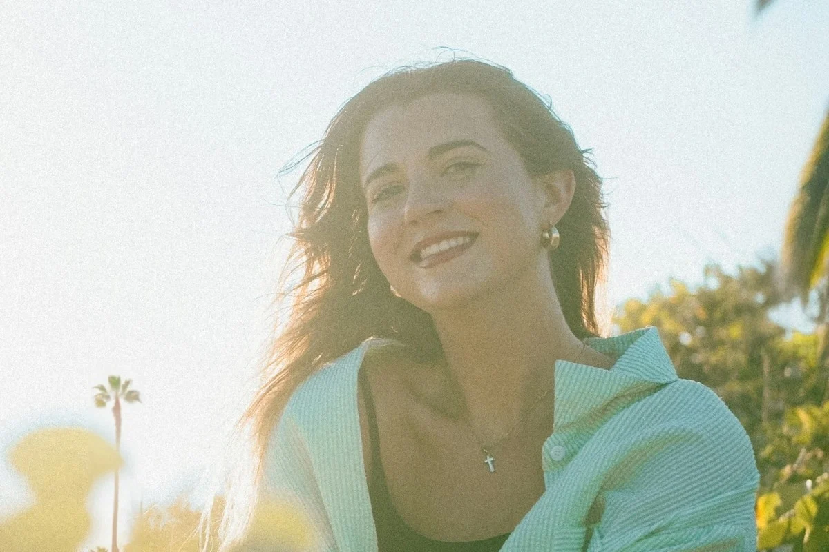 Woman smiling outdoors representing long-term oral health and confidence