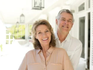 Portrait of senior couple smiling on porch