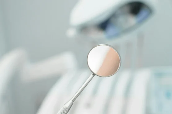 Dental mirror used during oral cancer screening and examination